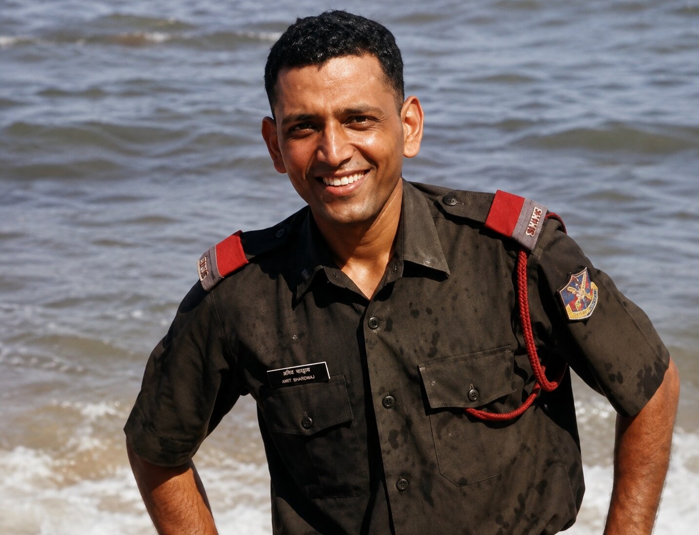 Captain Amit Bhardwaj smiling in uniform, nametag visible