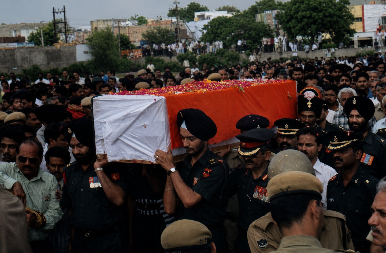 Captain Amit Bhardwaj's funeral procession, casket carried by soldiers through a large crowd